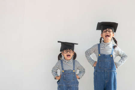 Siblings children girl graduation with capの写真素材