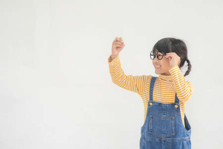 Little children painting on white wallの写真素材