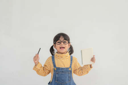 Portrait of funny smiling little girl child wearing glassesの写真素材