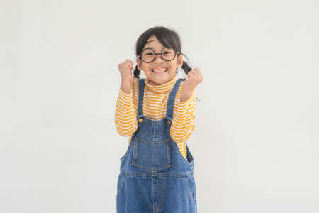 Portrait of funny smiling little girl child wearing glassesの写真素材