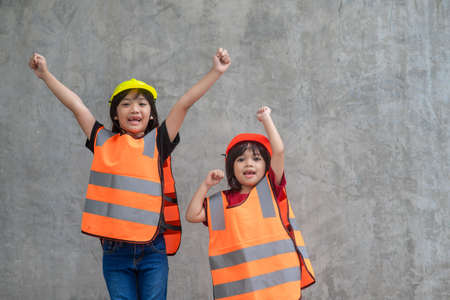 Portrait of sibling girl with a construction hat.の写真素材