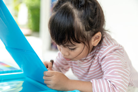 Little kids drawing with a colored pencil is a good activity for improving creative art and handwriting skills in children. Concept picture for education and learning hobby.の写真素材
