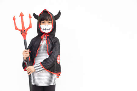 Asian little girl in a Halloween costume in a medical mask . Halloween with safety measures from Covid-19の写真素材