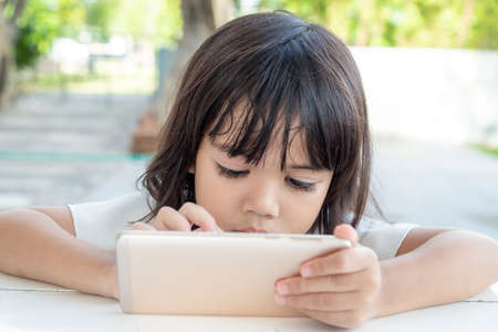 Little girl using smartphone, Social media concept.