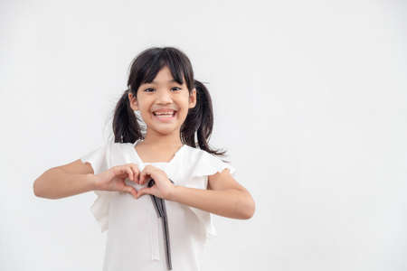 Little girl hands making a heart shape on white backgroundの写真素材