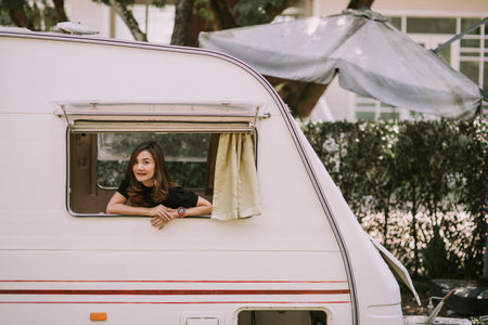Happy beautiful pretty asian woman by motorhome window