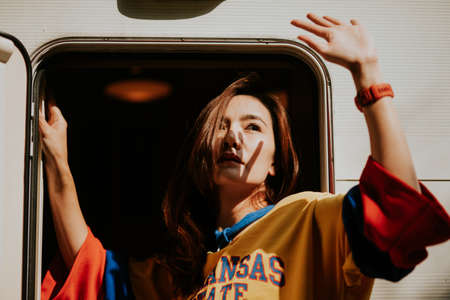 Summer sunny lifestyle fashion portrait of young woman enjoy weekends, travel