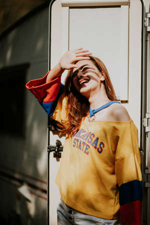 Summer sunny lifestyle fashion portrait of young woman enjoy weekends, travel
