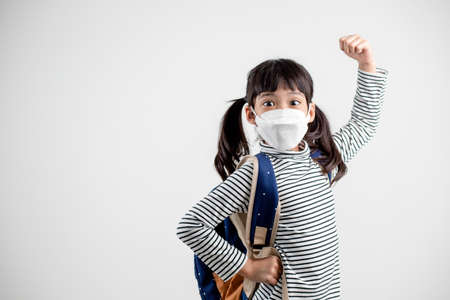 Child with face mask going back to schoolの写真素材