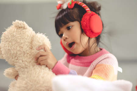 Happy holidays Cute little child opening present. The girl enjoyed the gift.の写真素材