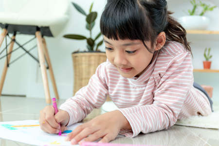 Cute little preschooler child drawing at homeの写真素材