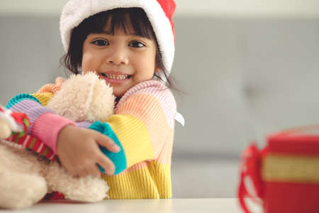 Happy holidays Cute little child opening present. The girl enjoyed the gift.の写真素材