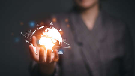 woman holding circle global network connection and data exchanges worldwide on workplace background, business network communication, and technology conceptの写真素材