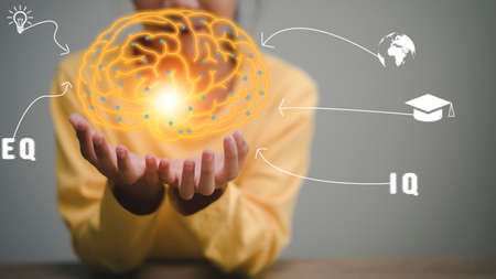 little girl's hands holding the brain.for development ahead tiny person concept. Progress direction...