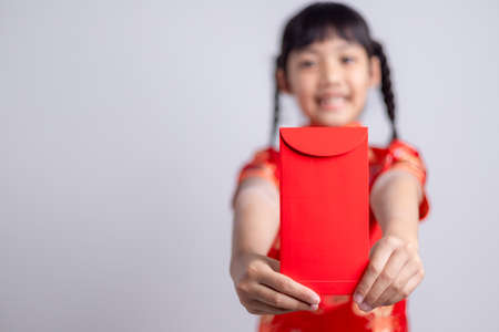 happy Chinese new year. smiling Asian little girls holding red envelopeの写真素材