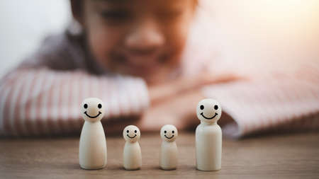 wooden doll family happy face, family home, adoption foster care, homeless support , family mental health, domestic violence, social distancingの写真素材