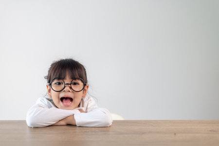 Cute little girl child in eyeglasses isolated. Education, school and vision conceptの写真素材