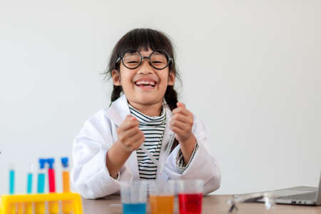 happy little girl with flasks for chemistryの写真素材