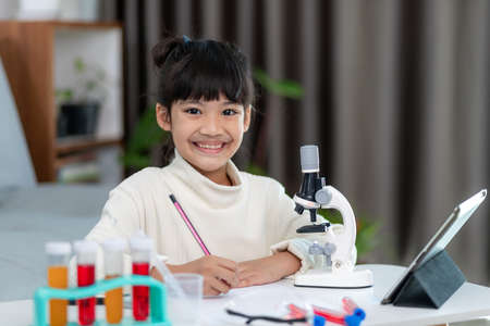 young girl play science experiments for homeschooling