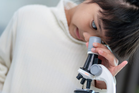 young girl play science experiments for homeschoolingの写真素材