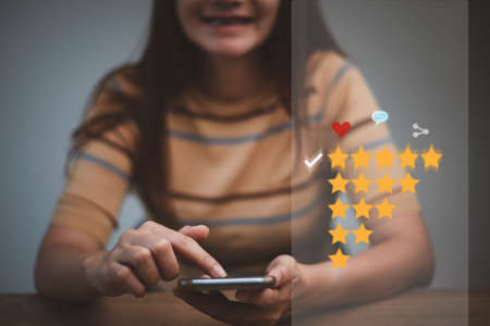 Customer evaluation feedback.women Giving Positive Review for Client's Satisfaction Surveys.giving a five star rating. Service rating, satisfaction conceptの写真素材