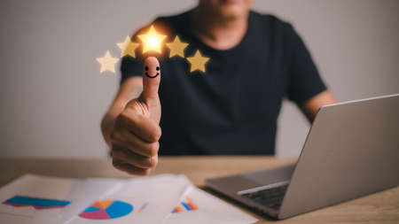 Customer experience satisfaction concept. Hand of client with thumb up Positive emotion smiley face...