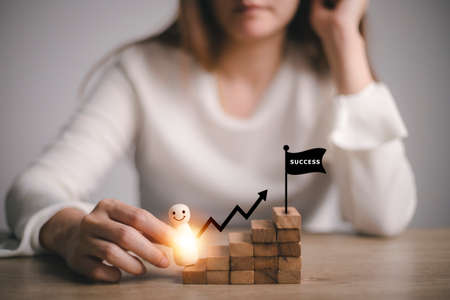 businesswoman holding Wooden figures climbing on stairs, success, Career development, and job...