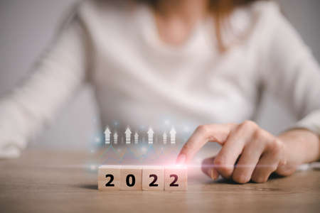 start to the year 2022,  hand touching wood cube for 2022 years. creative background for the new year. happy new years concept.の写真素材