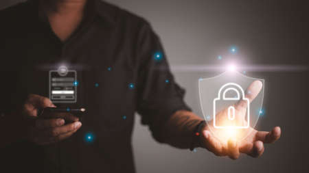 Protection network security computer and safe your data concept, Businessman holding shield protect iconの写真素材