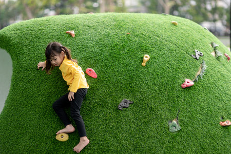 Asian little girl enjoys playing in a children playground, Outdoor portraitの写真素材