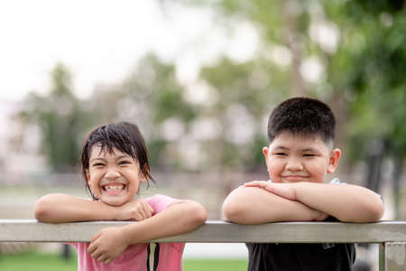 two little Asian children boy and girl Happy And smile in the park