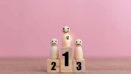 Wooden human standing on podium with ranking for winner business and sport competition concept.の写真素材