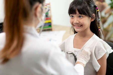 Doctor examining a little girl by stethoscope