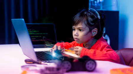 Asia students learn at home in coding robot cars and electronic board cables in STEM, STEAM, mathematics engineering science technology computer code in robotics for kids concept.の写真素材