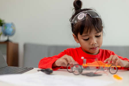 Asia students learn at home in coding robot cars and electronic board cables in STEM, STEAM,...