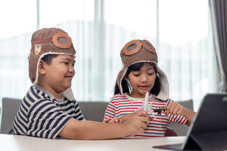 Two children with airplanes in hands