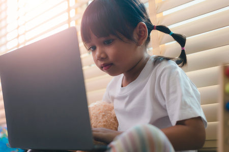Asian girl using Laptop computer for online study homeschooling during home quarantine. homeschooling, online study, home quarantineの写真素材