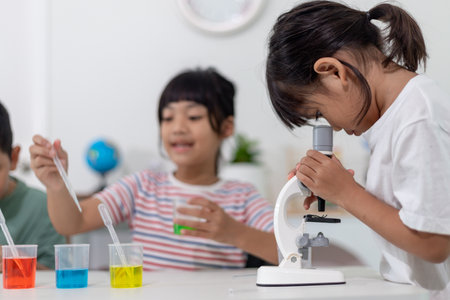 Asian Children enthusiastically watch chemistry experiments.の写真素材