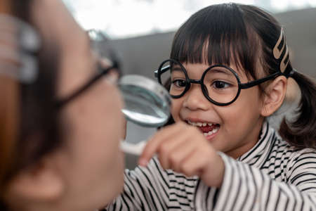 Cute Asian child playing with doctor dentist toy set, child shows how to clean and care for teeth....