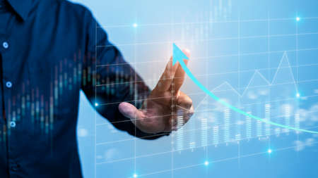 Businessman draws economic growth graph financial data.Stock market investment. Financial and...