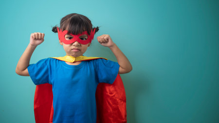 The little girl child in a superhero costume