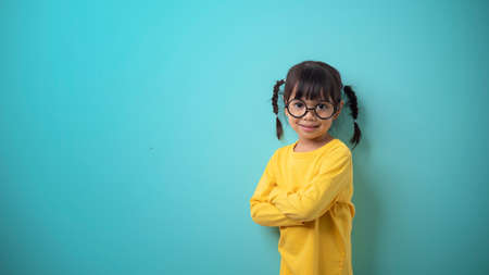 funny child girl wearing glasses on a colored background