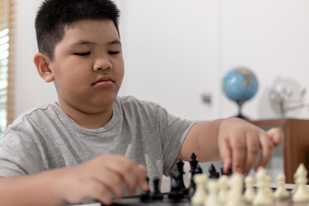 Little boy and little girl are playing chess at home.Children playing chessの写真素材