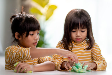 Kid play with handgum. Slime in children hands.の写真素材