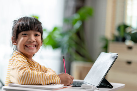 Kid self isolation using tablet for his homework,Child doing using digital tablet searching information on internet during covid 19 lock down,Home schooling,Social Distance,E-learning online educationの写真素材