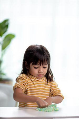 Kid play with handgum. Slime in children hands.の写真素材