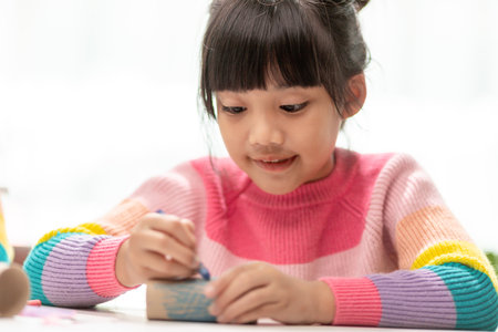 Little cute girl with painted tissue core. Art makes children learn and create.