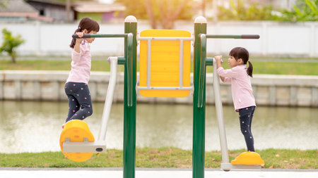 Asian little girl enjoys playing in a children playground, Outdoor portrait