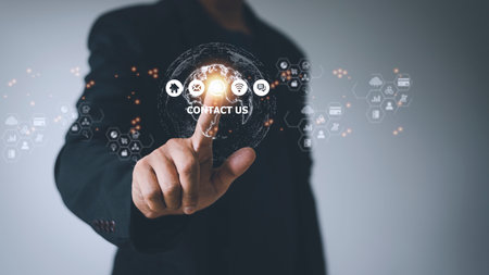 Contact us or Customer support hotline people connect. Businessman using smart phone and touching on virtual screen contact iconsの写真素材