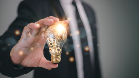 Businessman holding a bright light bulb. Concept of Ideas for presenting new ideas Great inspiration...